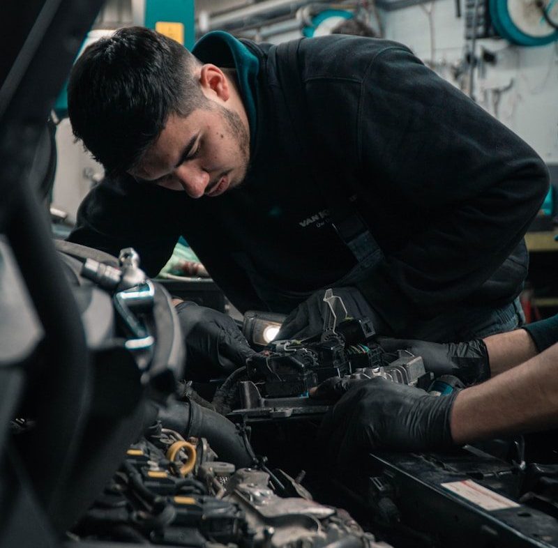 mechanic working on car engine