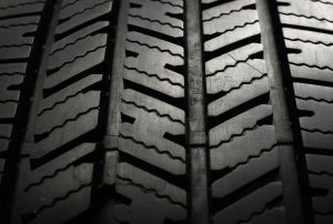 A close up of a tire on a black background