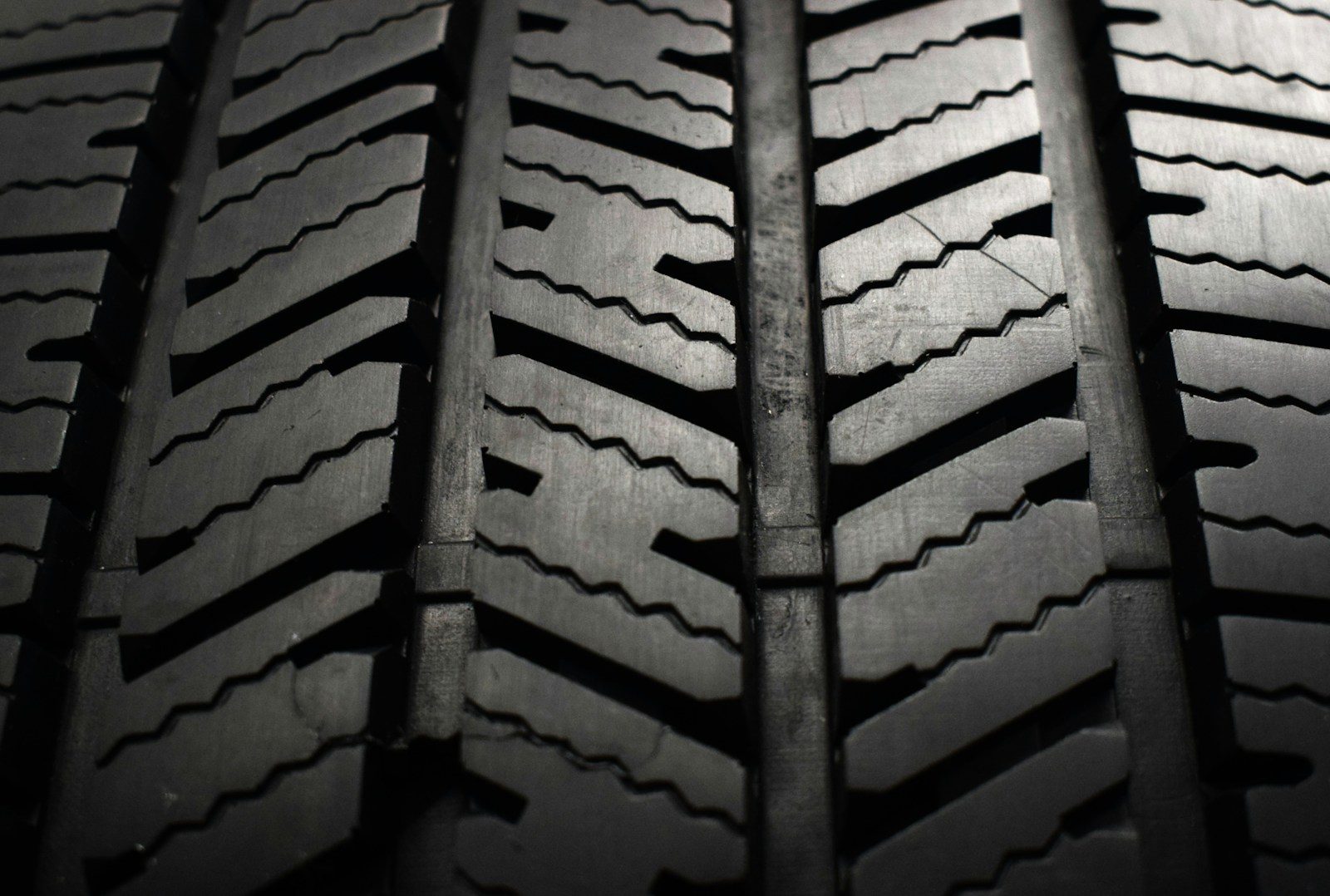 A close up of a tire on a black background